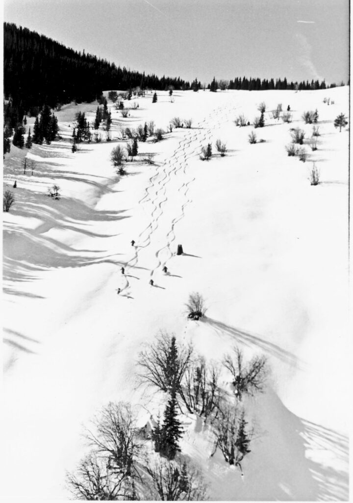 black and white image of skiers going down an original run at beaver creek