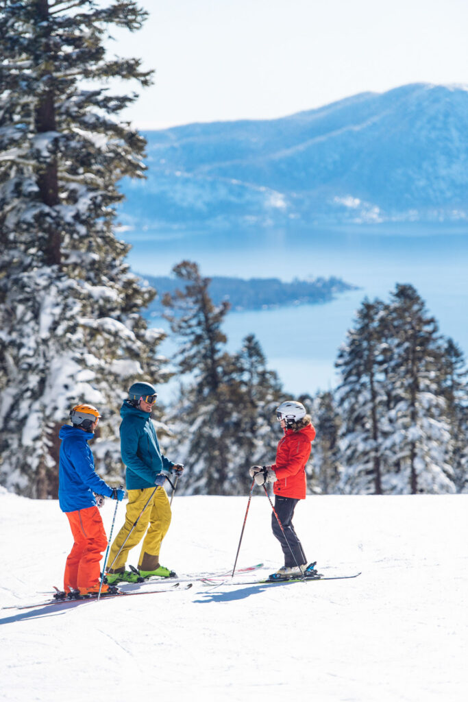 Family taking a break on a run at Northstar with the lake in the background