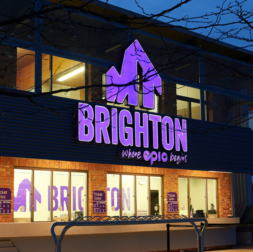 Image of a building with Mt. Brighton lit up in Purple