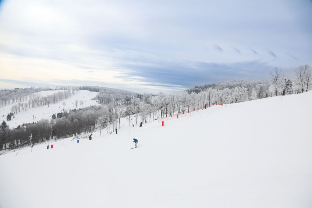 Skier going down a groomed run at Seven Springs