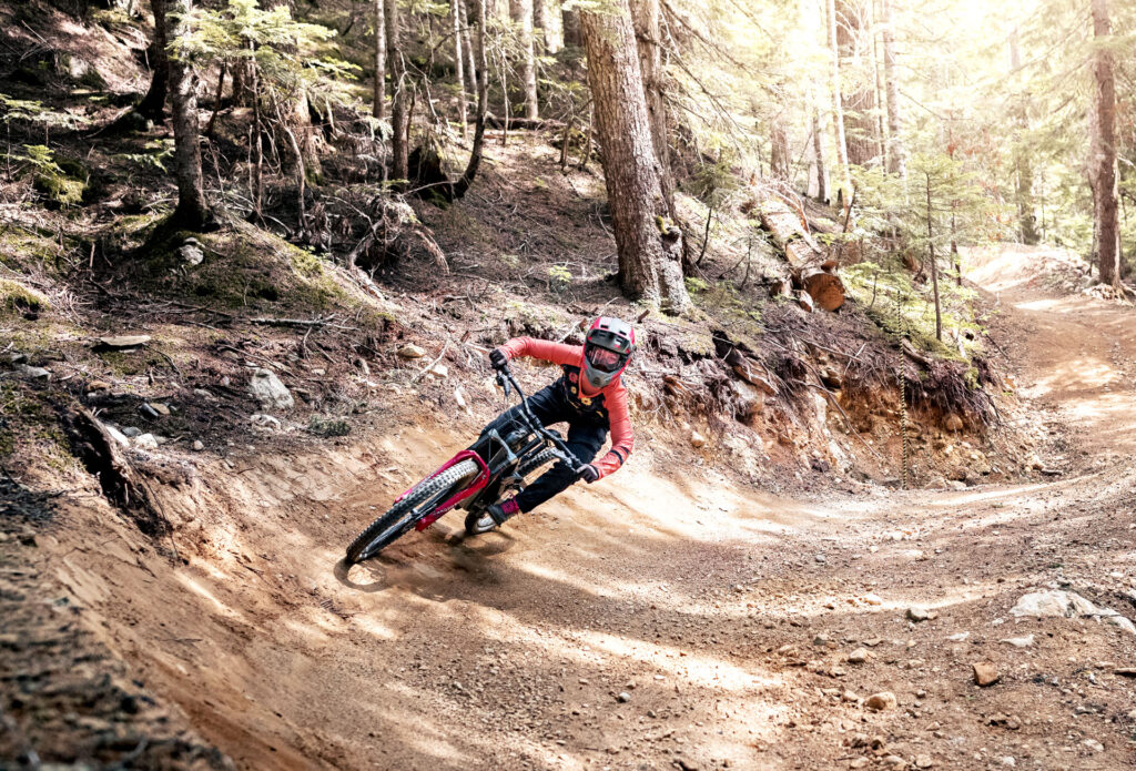 Woman riding mountain bike trail in the woods