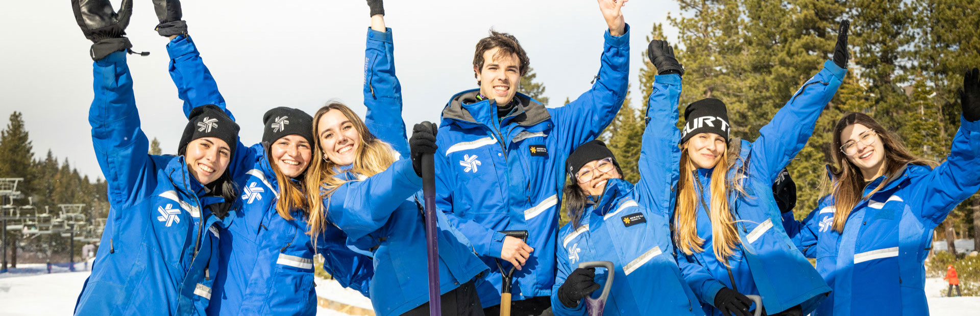 Group of northstar employees with arms in the sky showing happiness