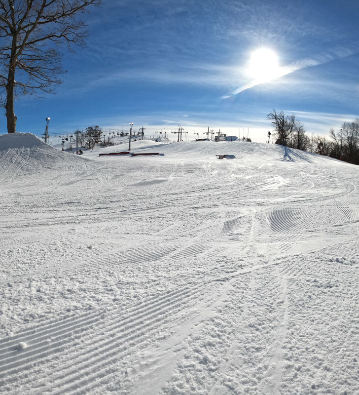 Image of lifts and the terrain park on a sunny day at Wilmot