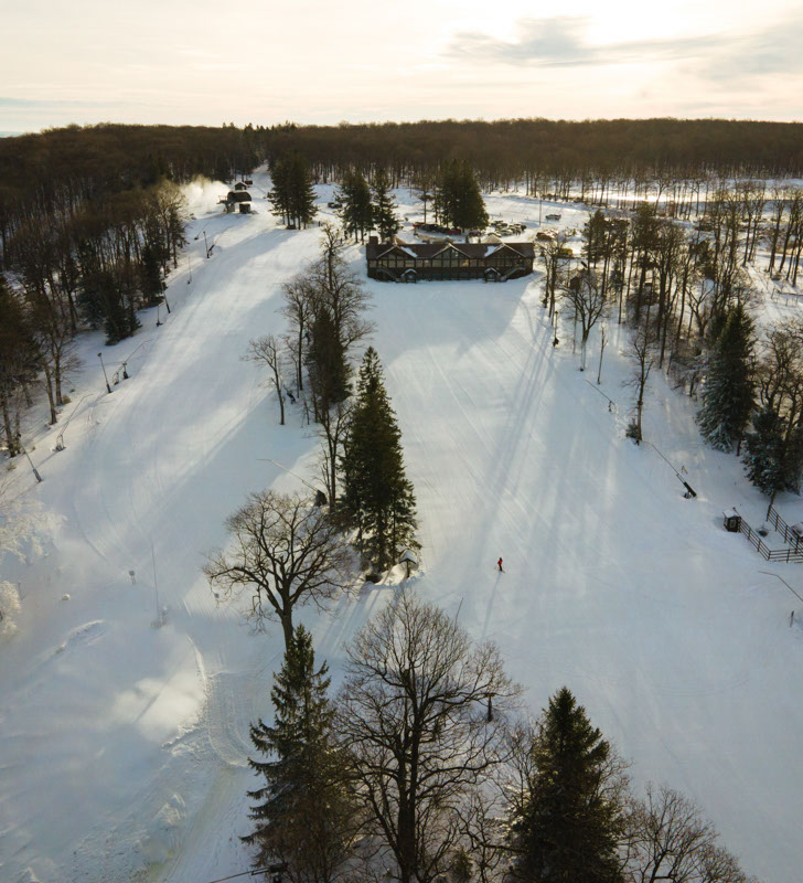 Aerial view of ski runs at lauren mountain with a lodge in view