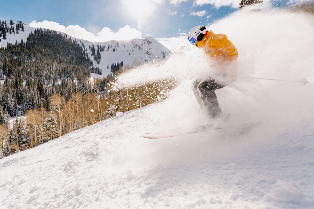 Skier jumping through powder at Park City Mountain