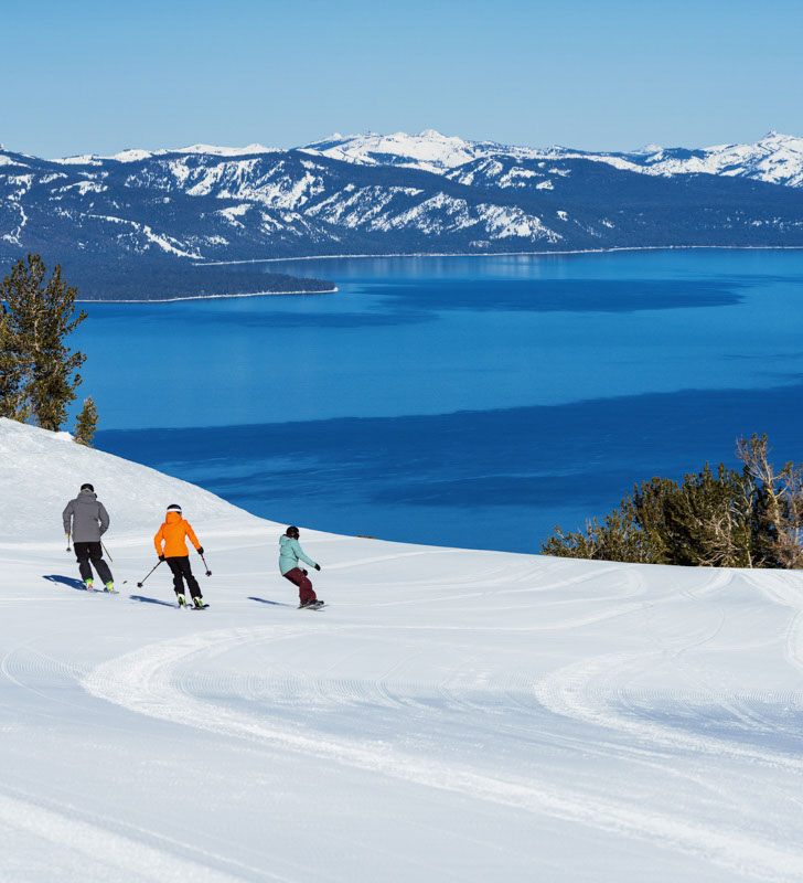 Friends Ski and Snowboard in Unison Down a Run at Heavenly with